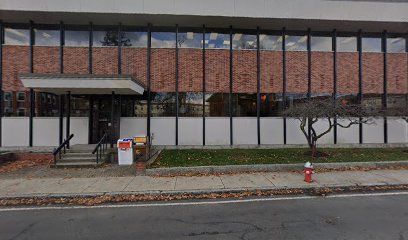 A large brick building with a fire hydrant in front of it.