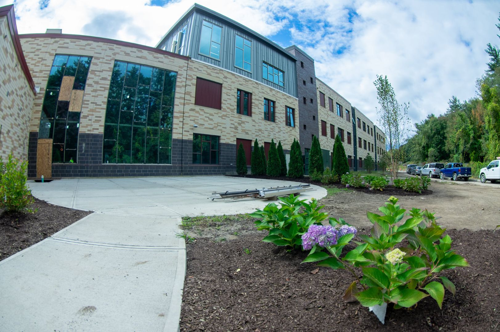 A large building with a lot of windows and flowers in front of it