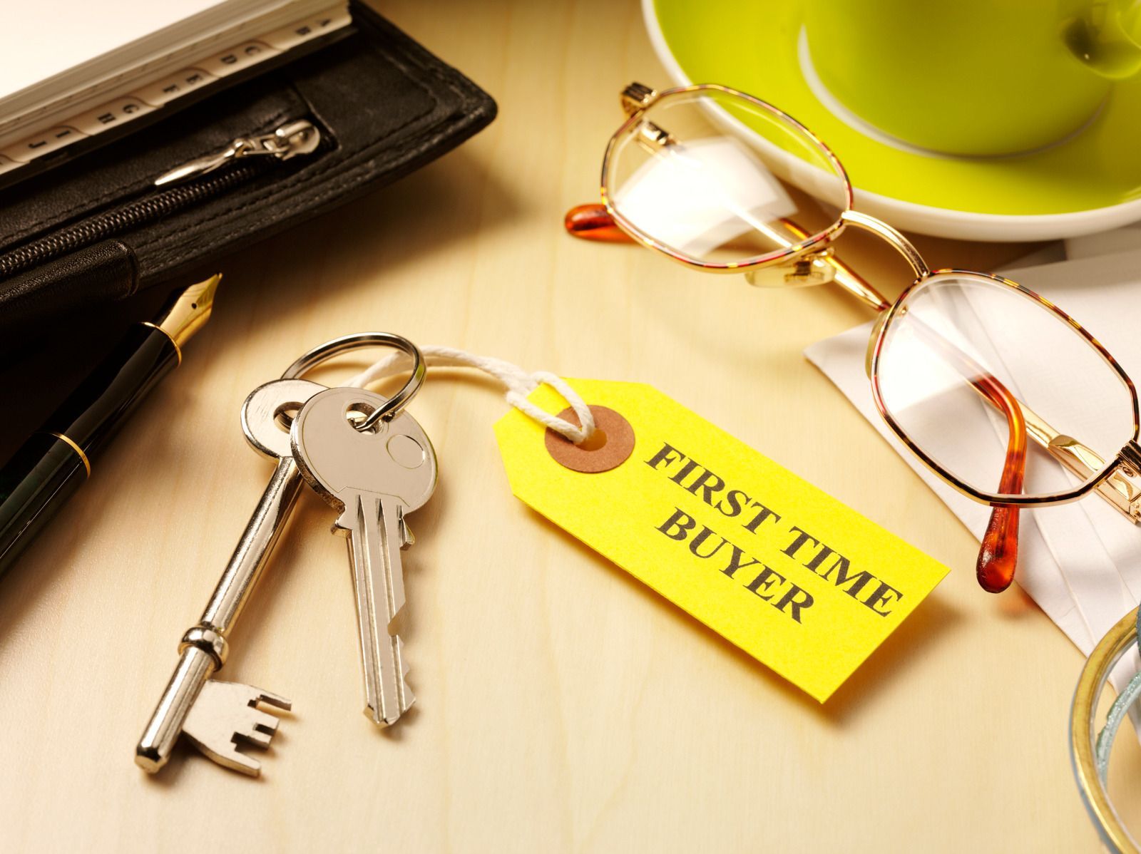 A pair of keys with a yellow tag that says first time buyer