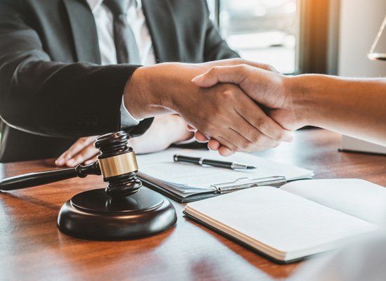 Law and Client Shaking Hands — Commerce, CA — Lopez Law Group