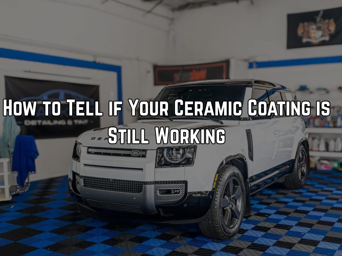 White SUV with ceramic coating in professional detailing shop being inspected for coating performanc