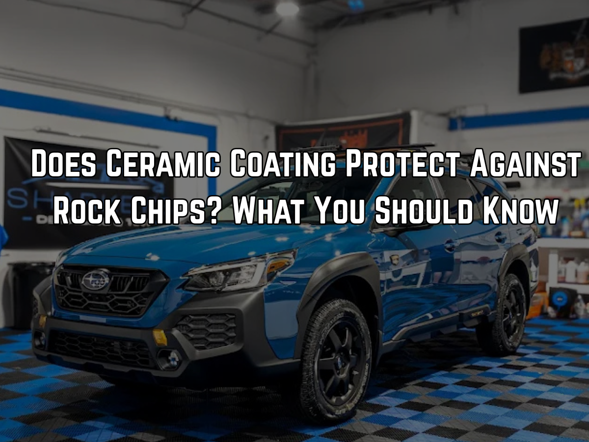 Blue Subaru in professional detailing shop for ceramic coating and rock chip protection consultation