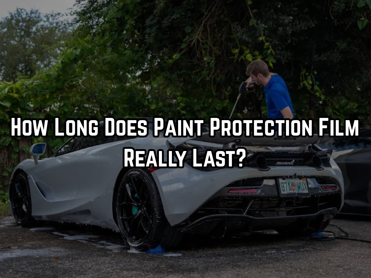 White McLaren supercar with paint protection film being maintained outdoors by professional detailer