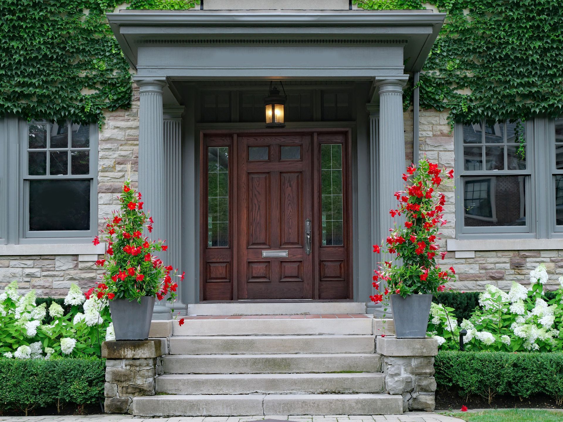 View of an elegant house with a wood grain door, installed by door contractors.
