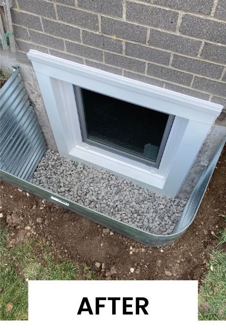 A picture of a window in the basement of a brick house.