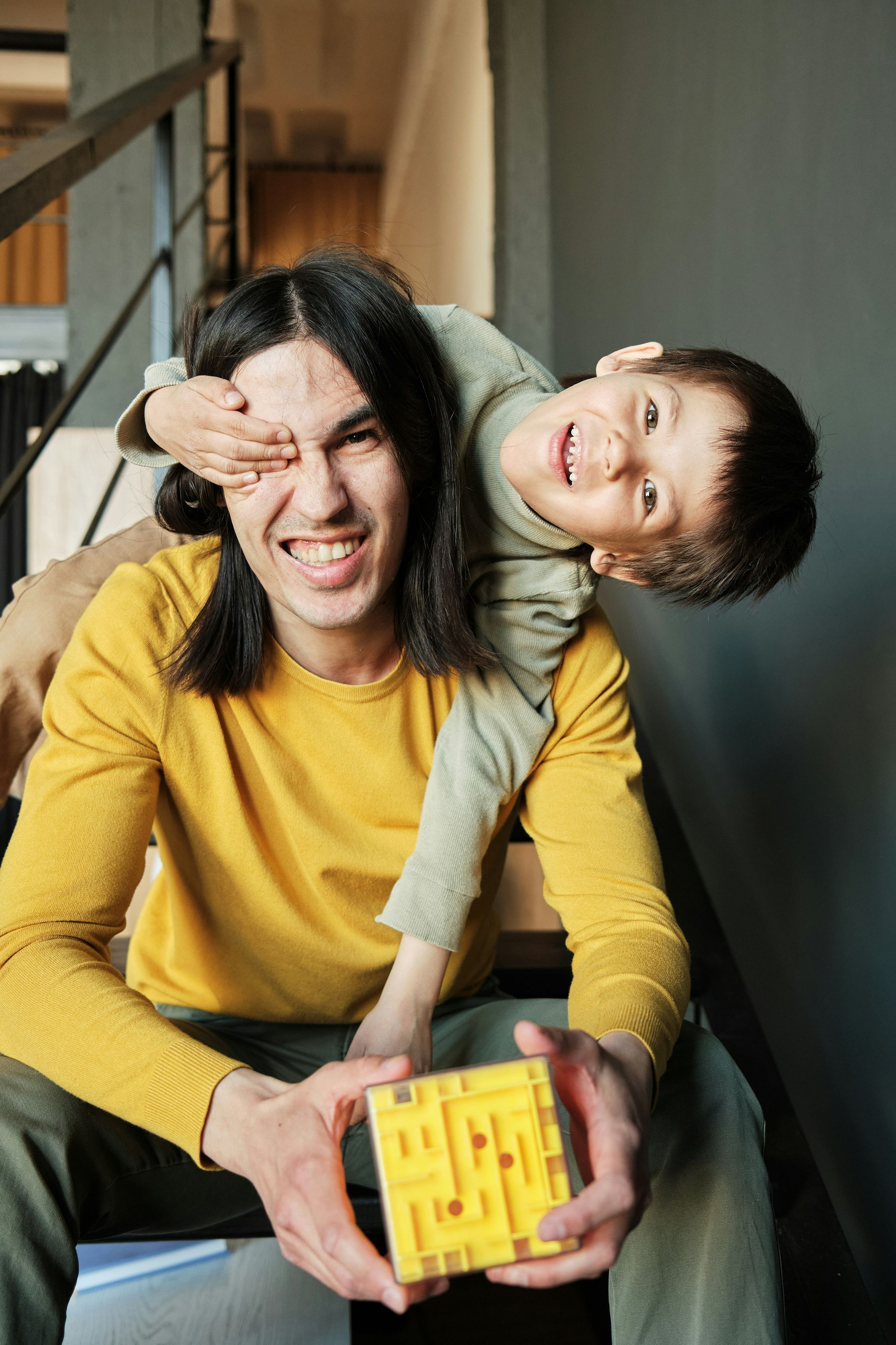 Red car with severe damage to the rear, loaded on a tow truck.