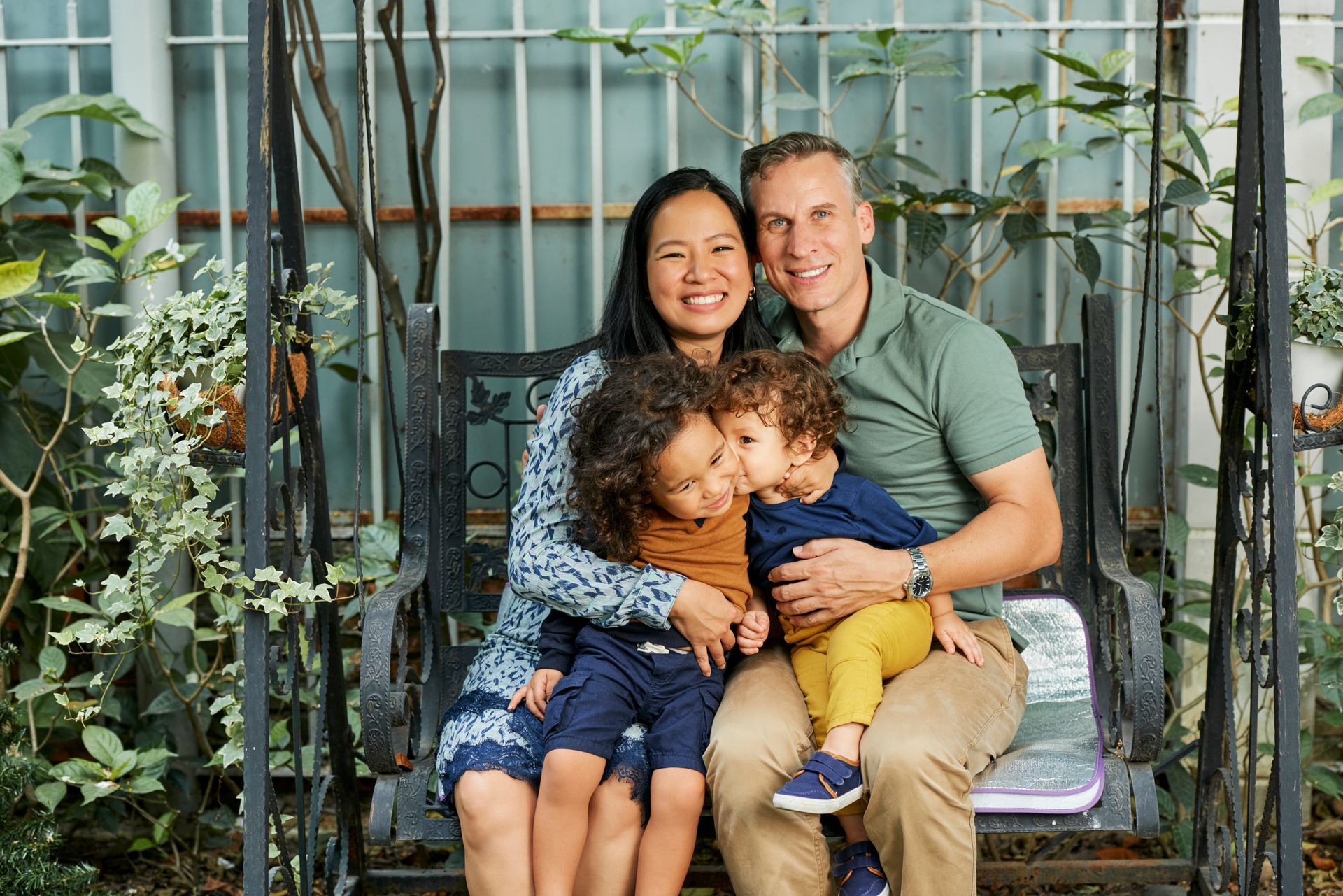 Woman holding wedding ring, man blurred in background, likely in a divorce setting.