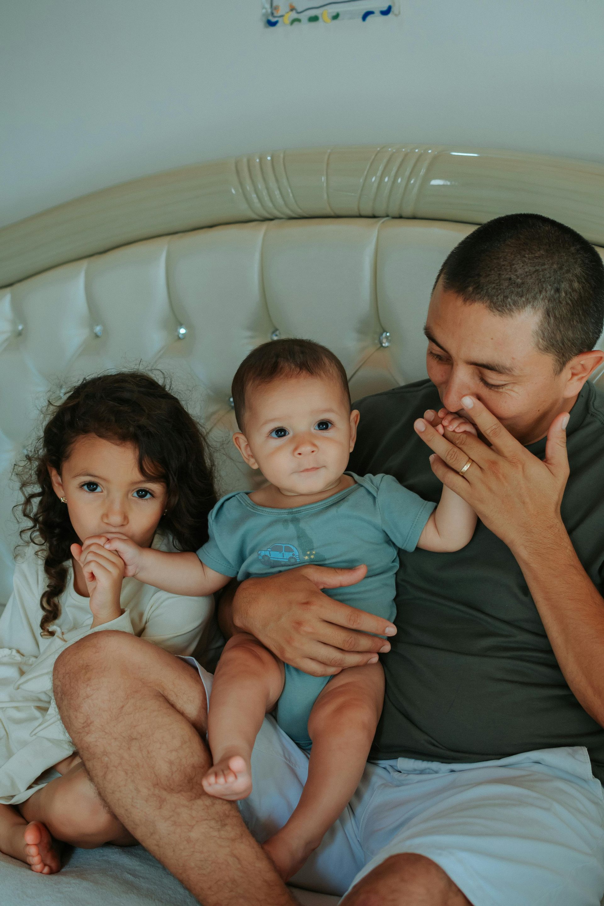 Red car with severe damage to the rear, loaded on a tow truck.