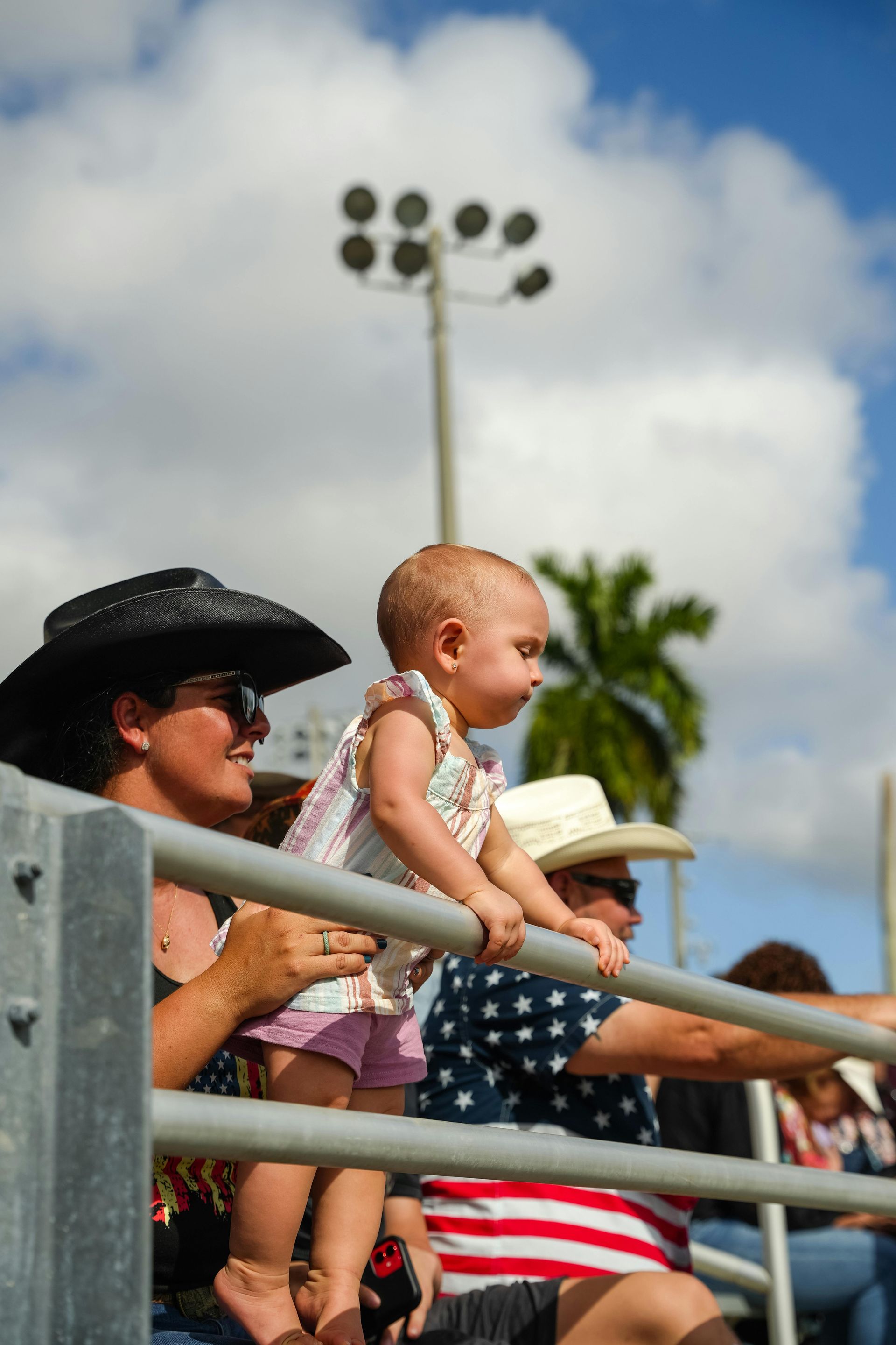 Red car with severe damage to the rear, loaded on a tow truck.