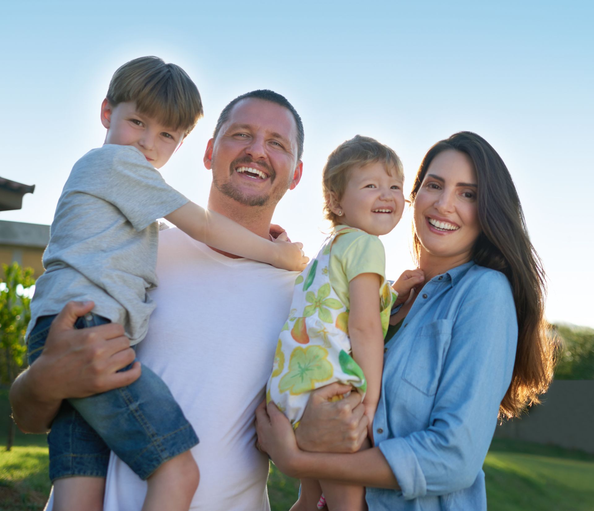 Girl in white dress crawling on sandy beach.
