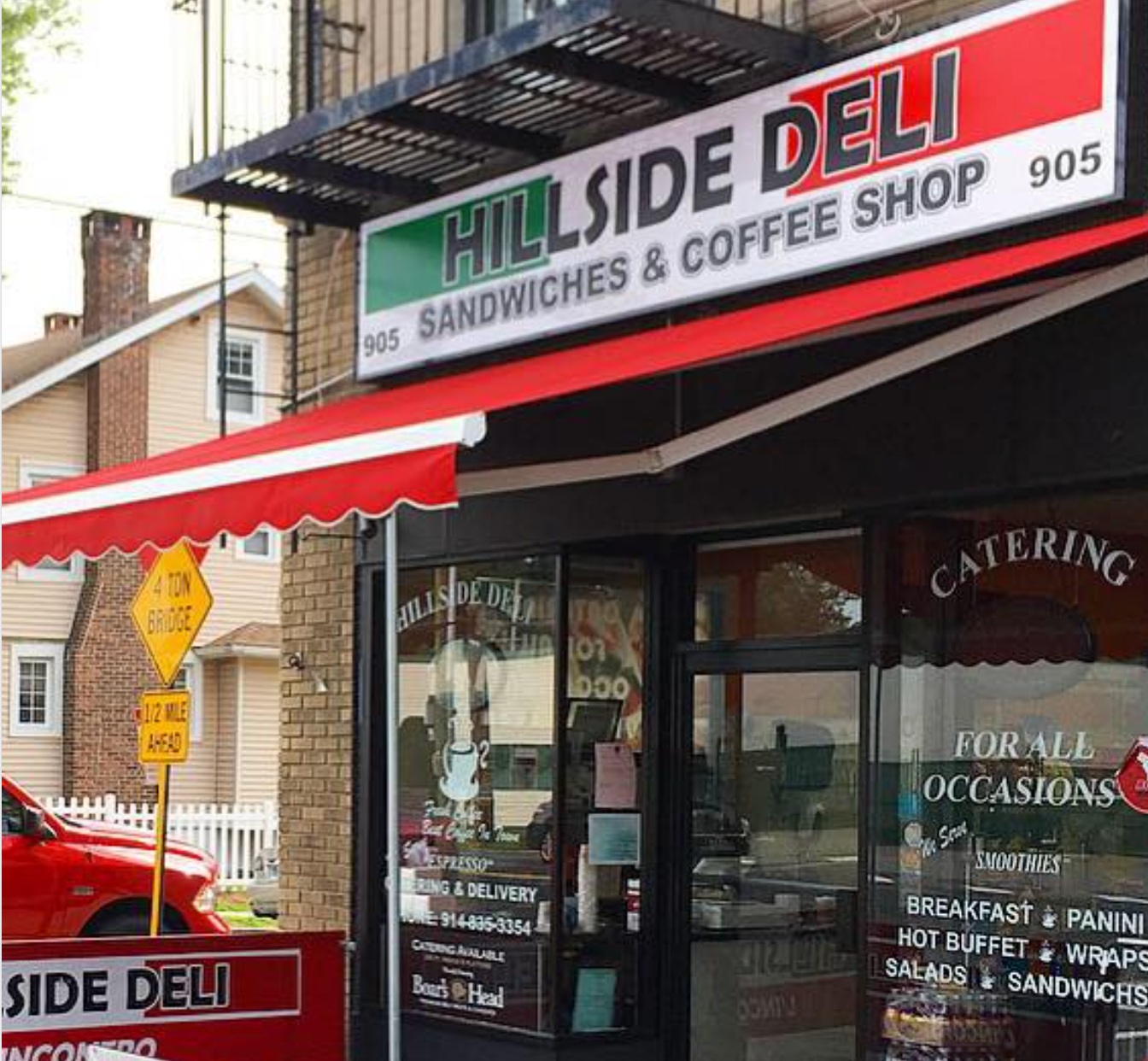 Exterior of Hillside Deli, a sandwich and coffee shop with a red awning.