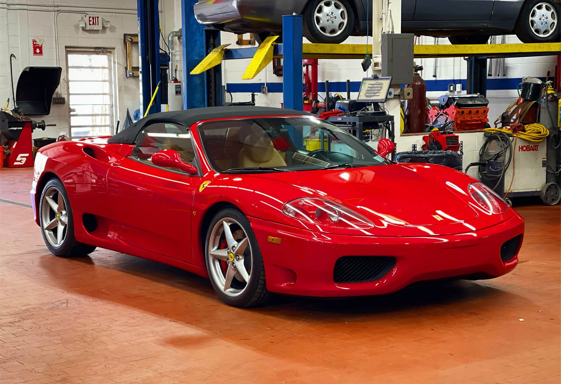Red Ferrari Convertible Inside Auto Repair Facility | Motorwerks Inc