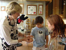 Instructor teaching children about cows