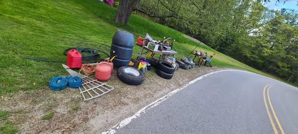 A bunch of trash is sitting on the side of a road.
