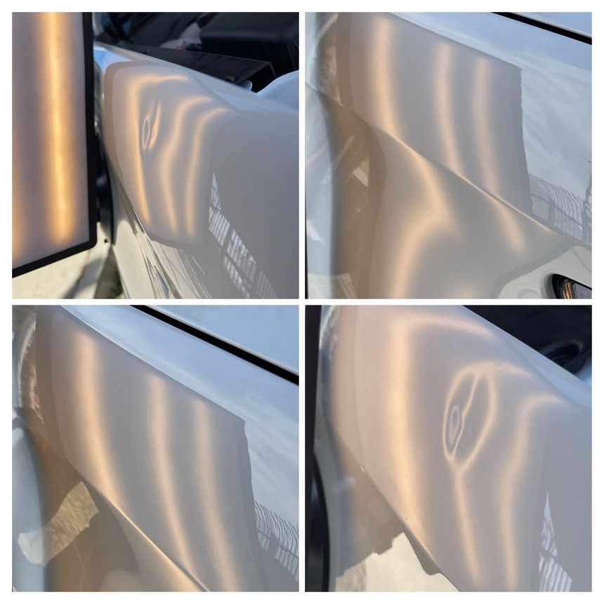 Damaged, reflective white metal panel with a large dent 