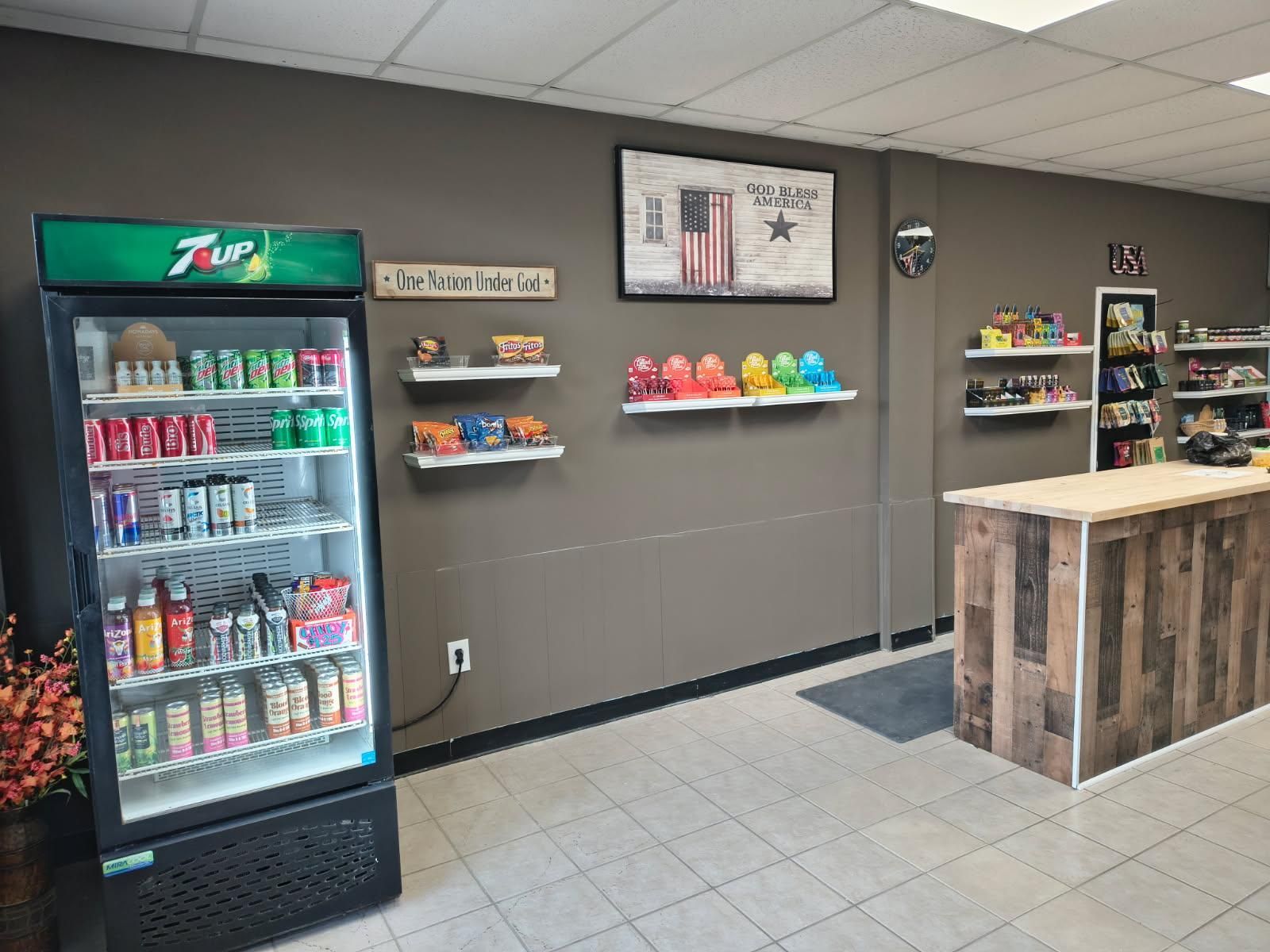 There is a 7 up fridge in the middle of the room.