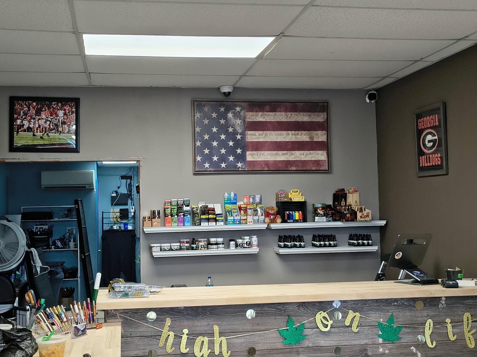 A counter in a store with an american flag on the wall.