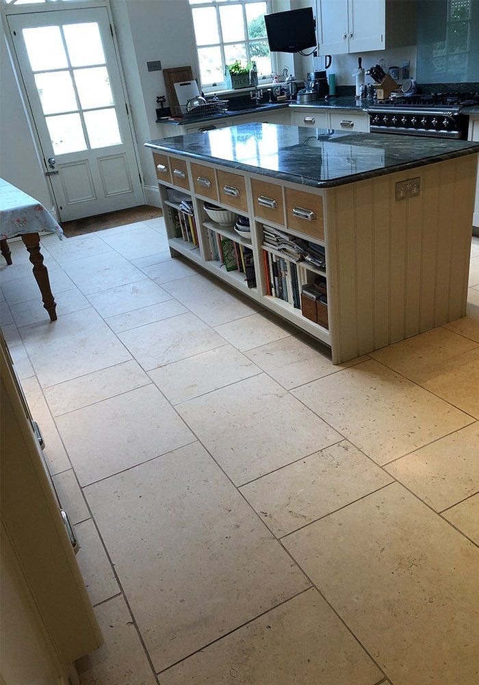 kitchen with marble kitchen top and natural stone floor