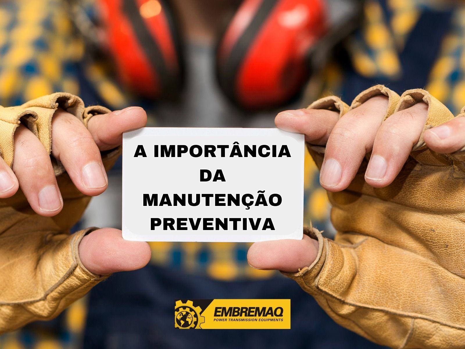 Mechanic holding a sign about the importance of preventive maintenance