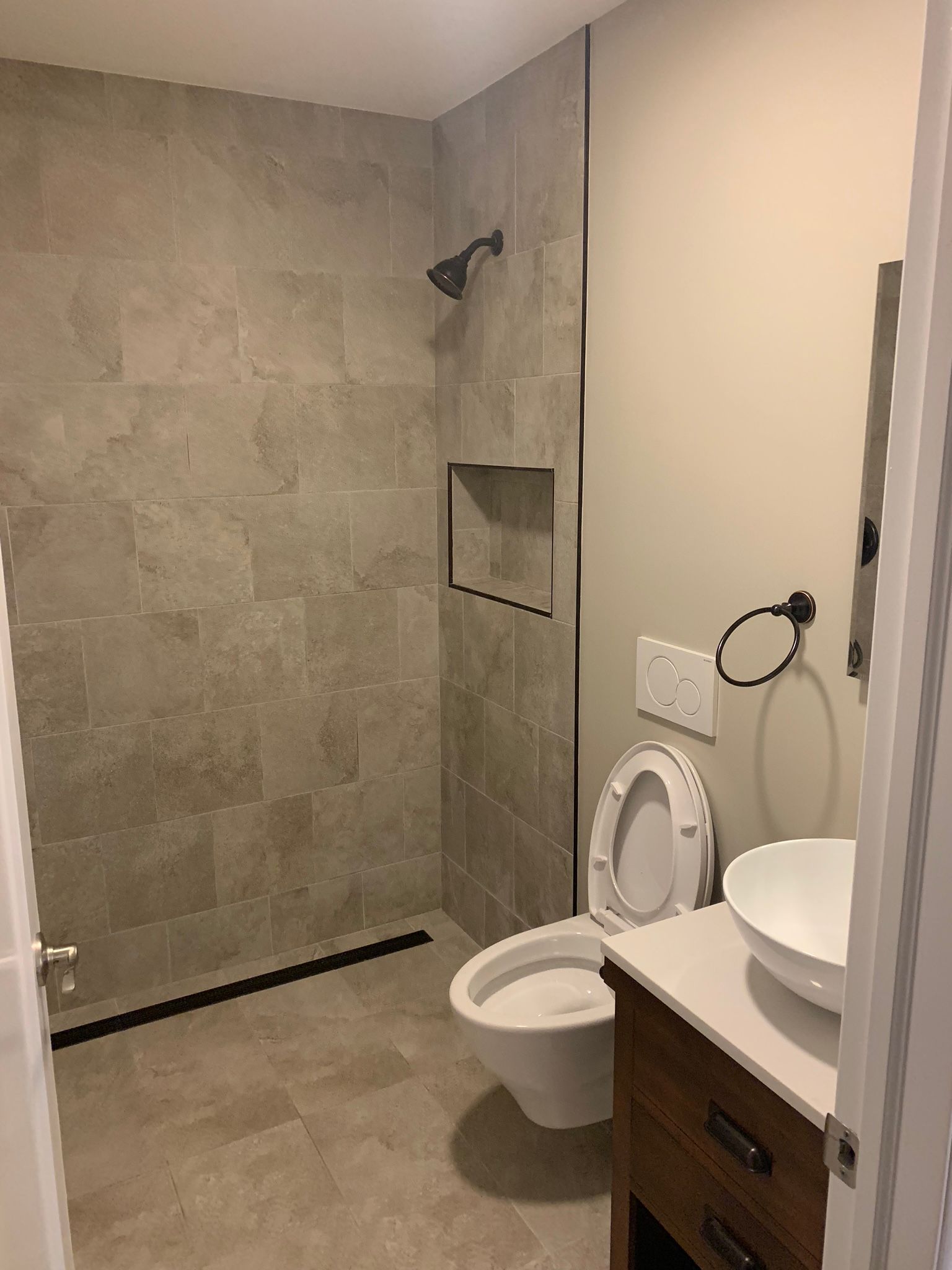 A bathroom with a toilet a sink and a shower Bathroom Remodel Contractors New Orleans