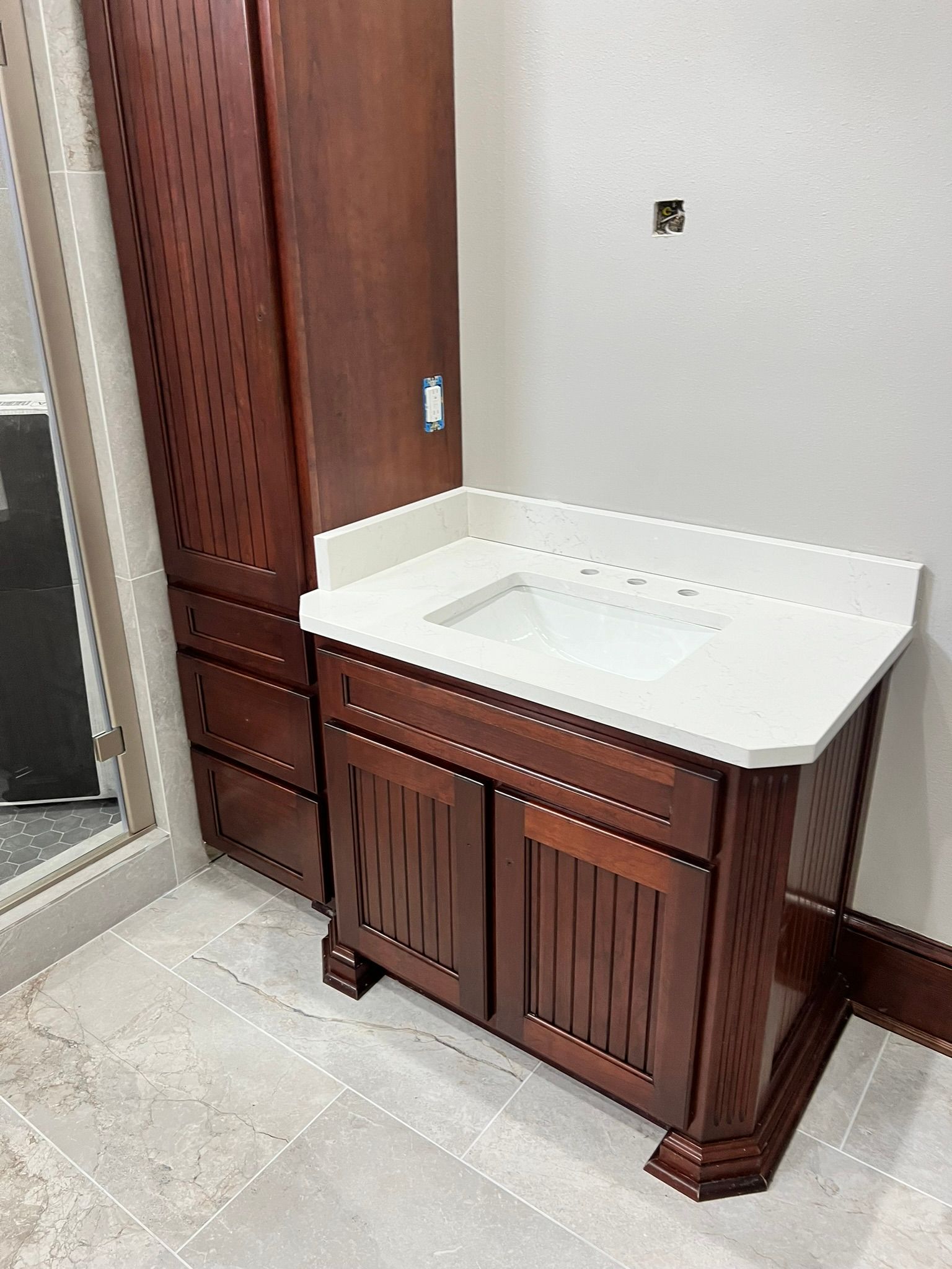 A bathroom with wooden cabinets and a sink Bathroom Remodeling Services New Orleans