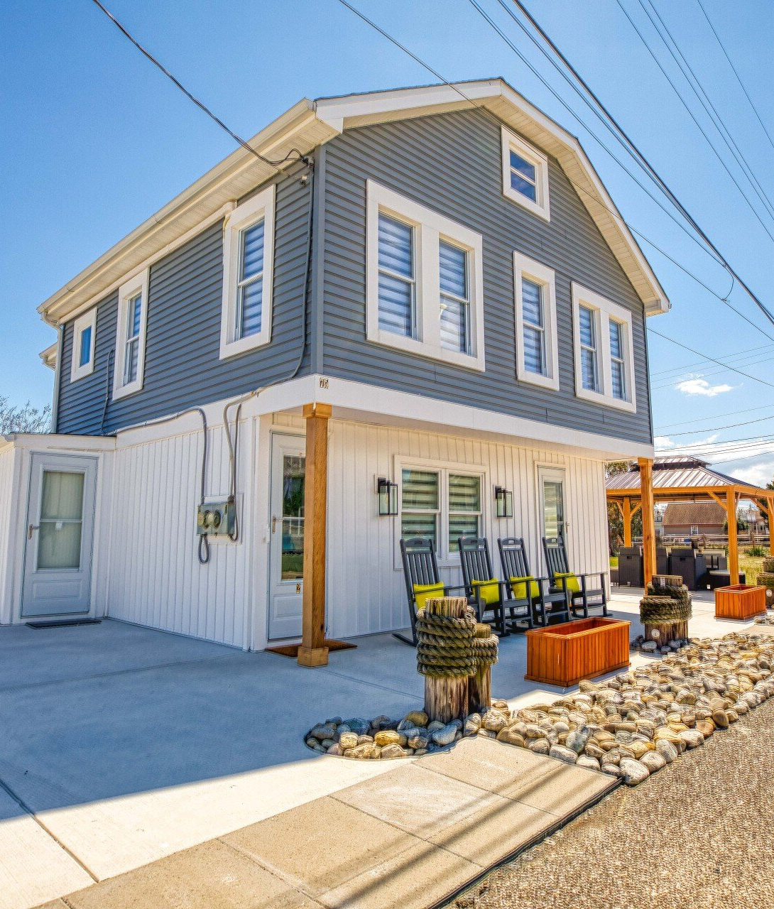 A large gray and white house with a lot of windows
