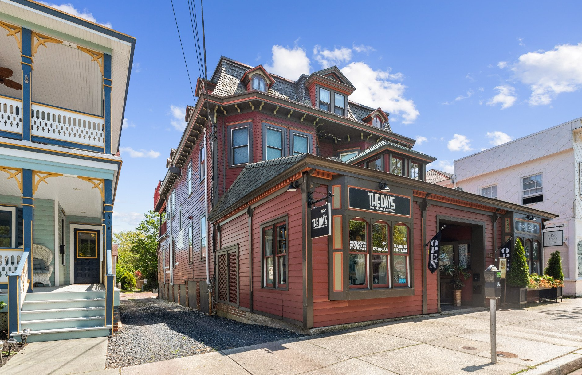 A large red building is sitting on the corner of a street.