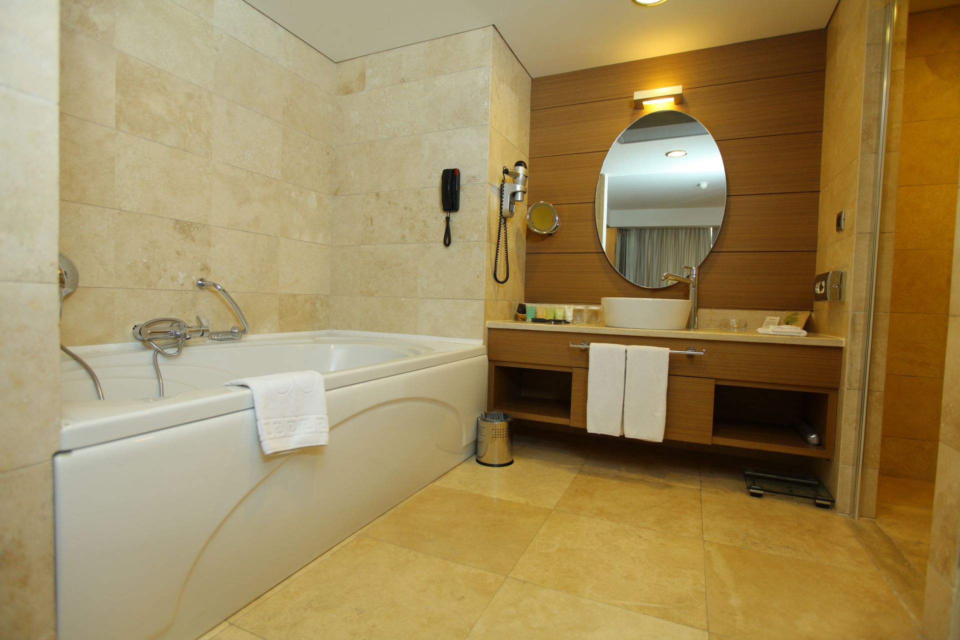 A bathroom with a bathtub , sink and mirror.