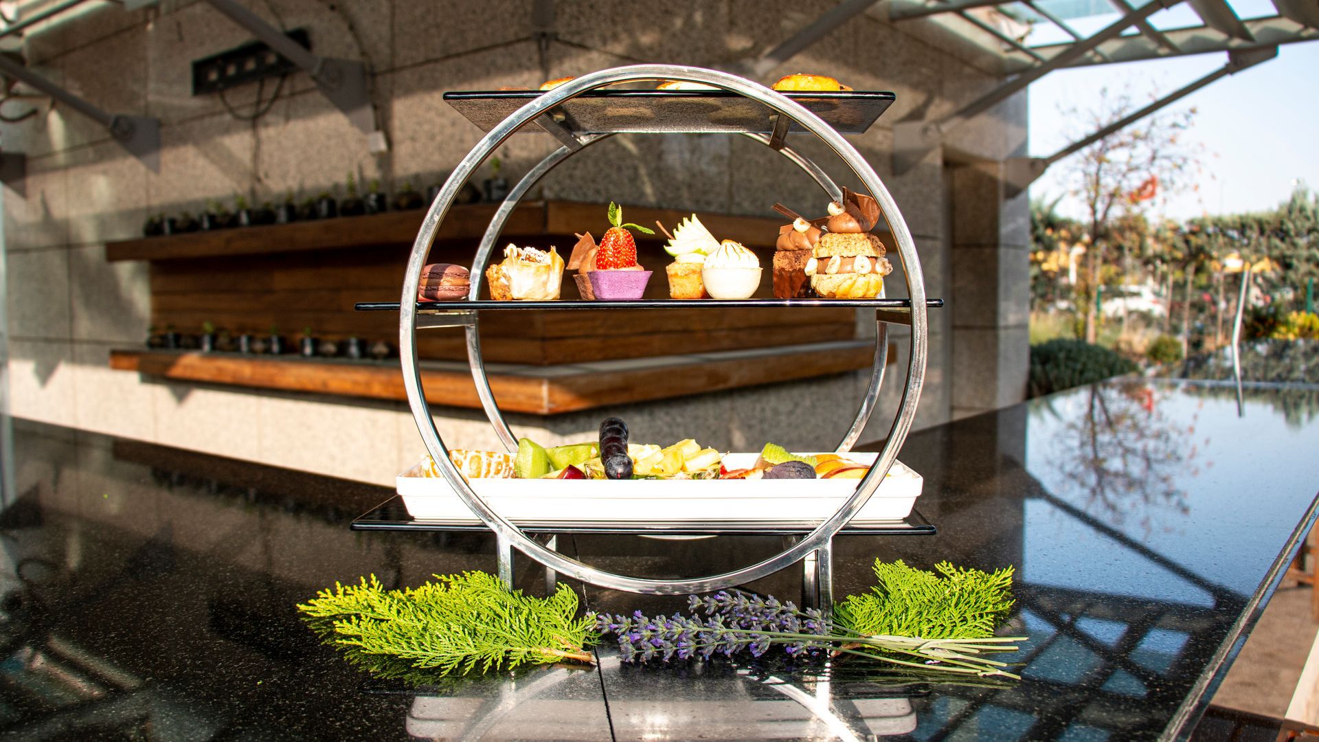 A tray of food is sitting on a table next to a pool.