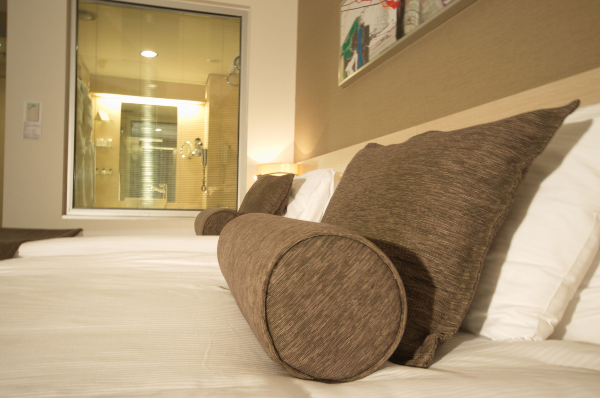 A hotel room with two beds and a large window.