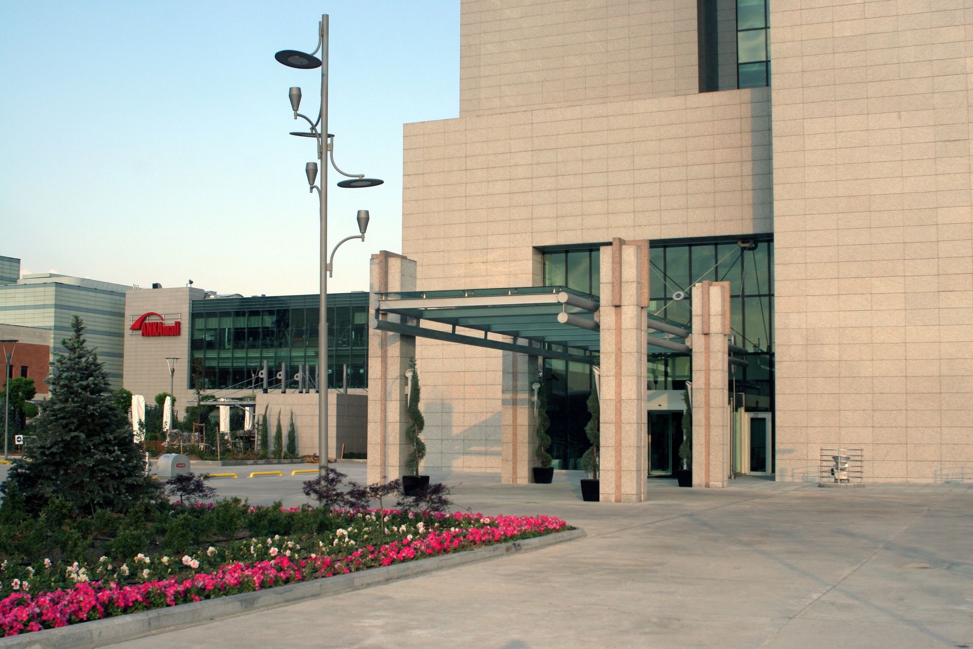 A large building with a canopy and flowers in front of it