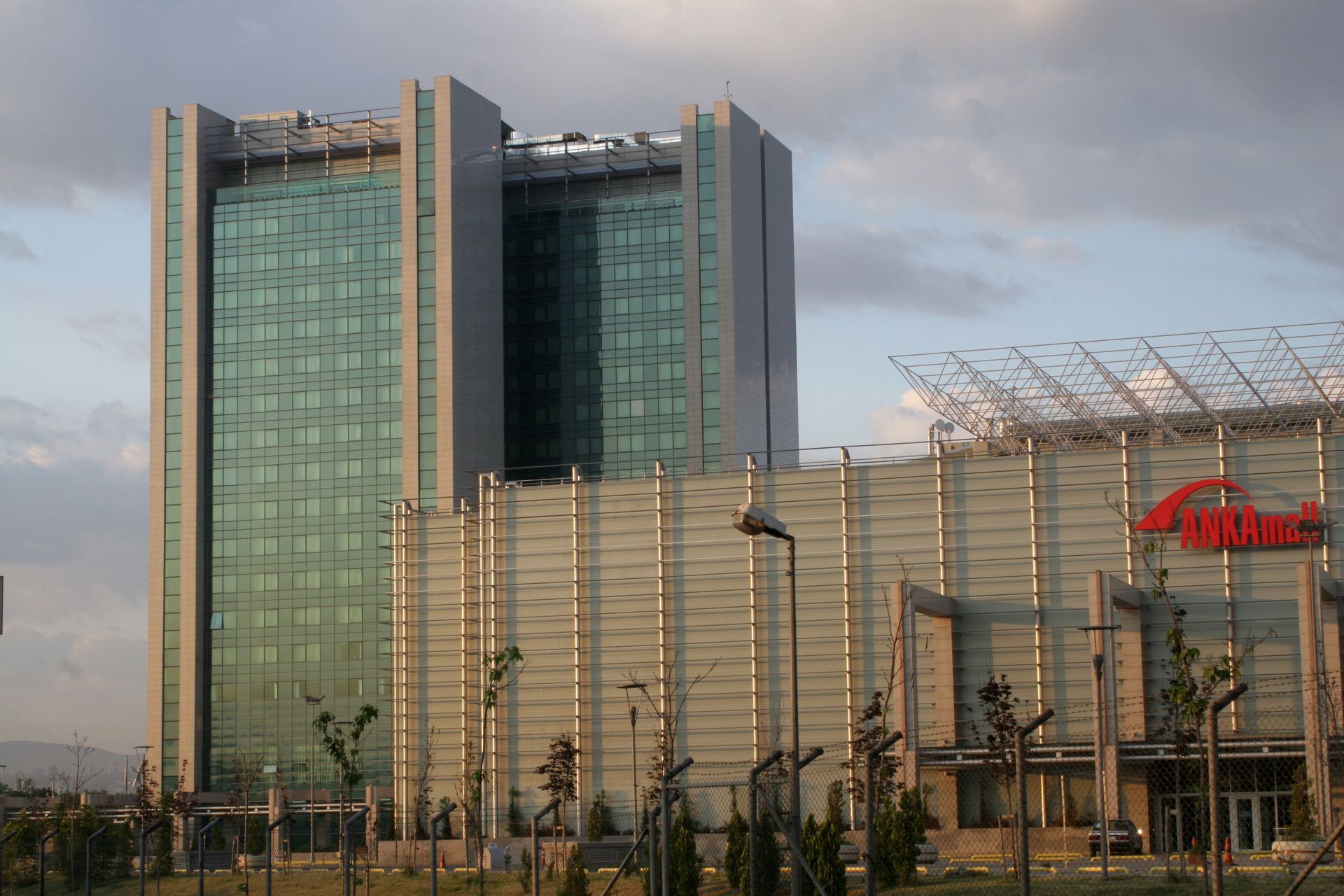 A large building with a lot of windows is surrounded by trees.