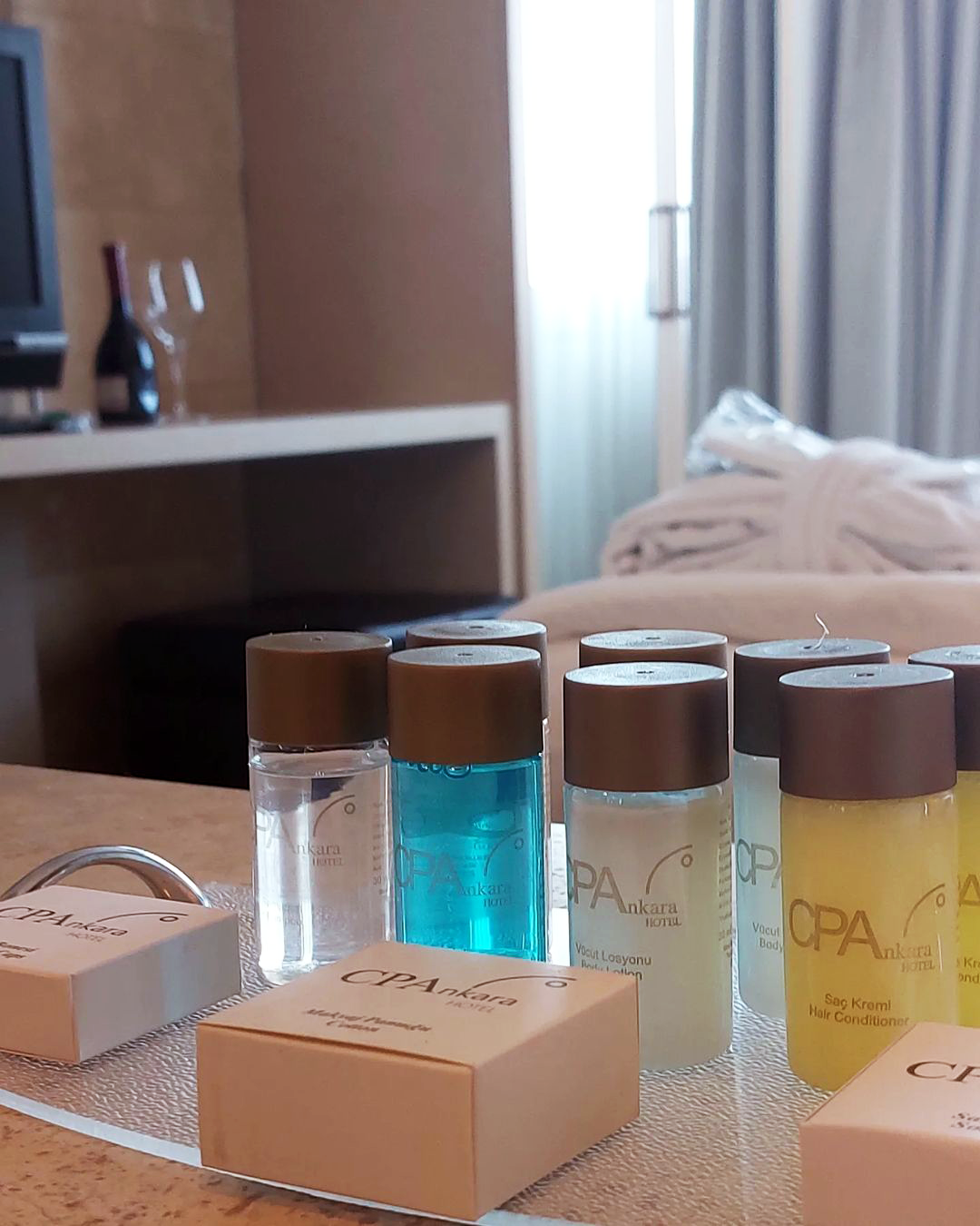 Several bottles of spa products are lined up on a table