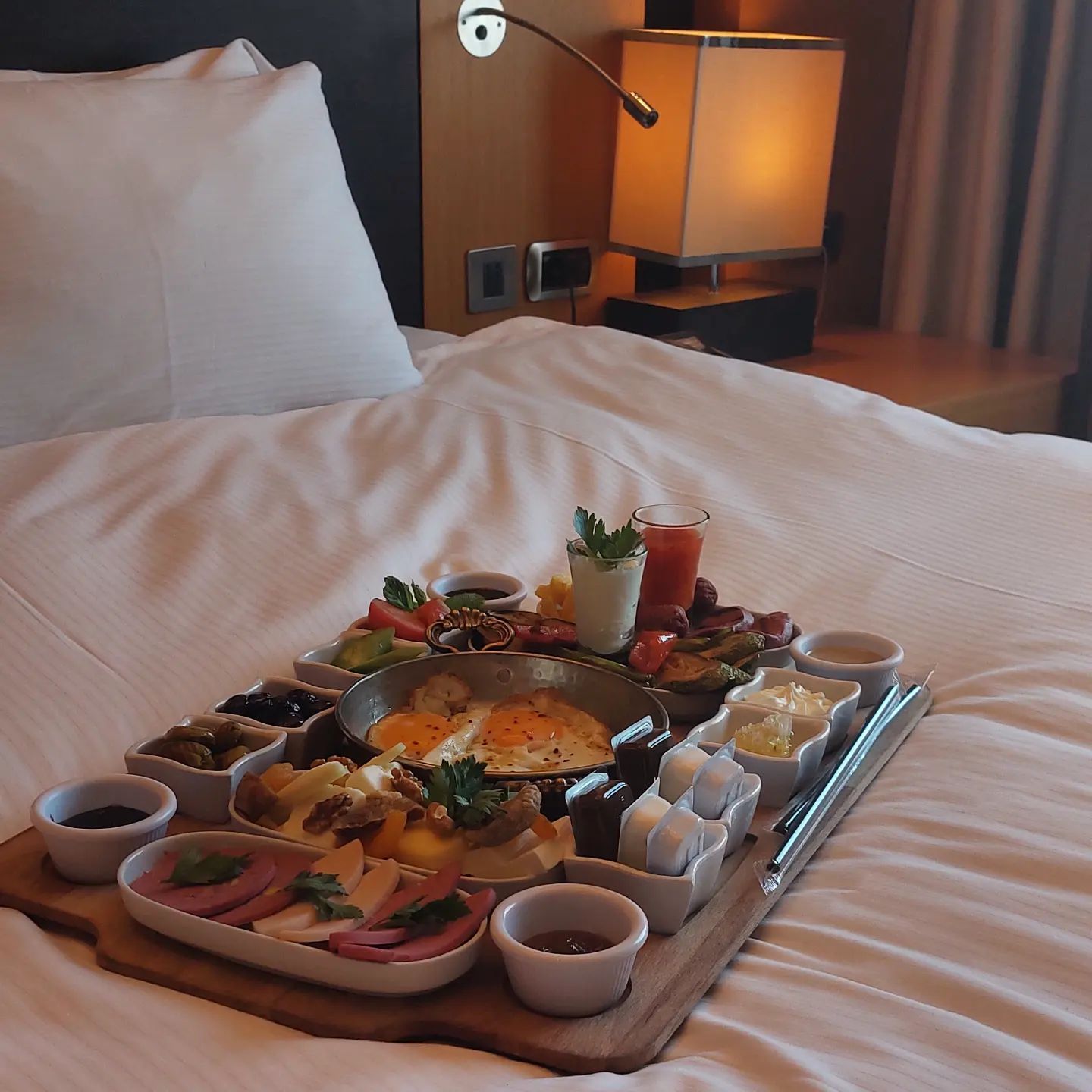 A bed with a tray of food on it