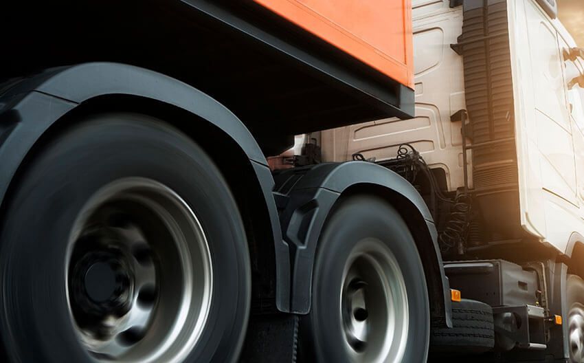 A close up of the wheels of a semi truck.