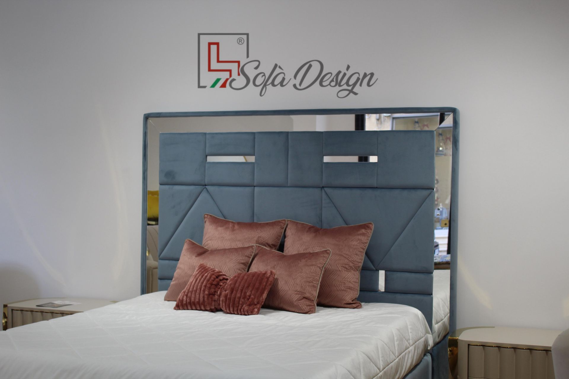 Ufficio in casa con scrivania, sedia, computer e quadri alle pareti. Sedia in pelle marrone, scrivania in legno, pareti azzurre.