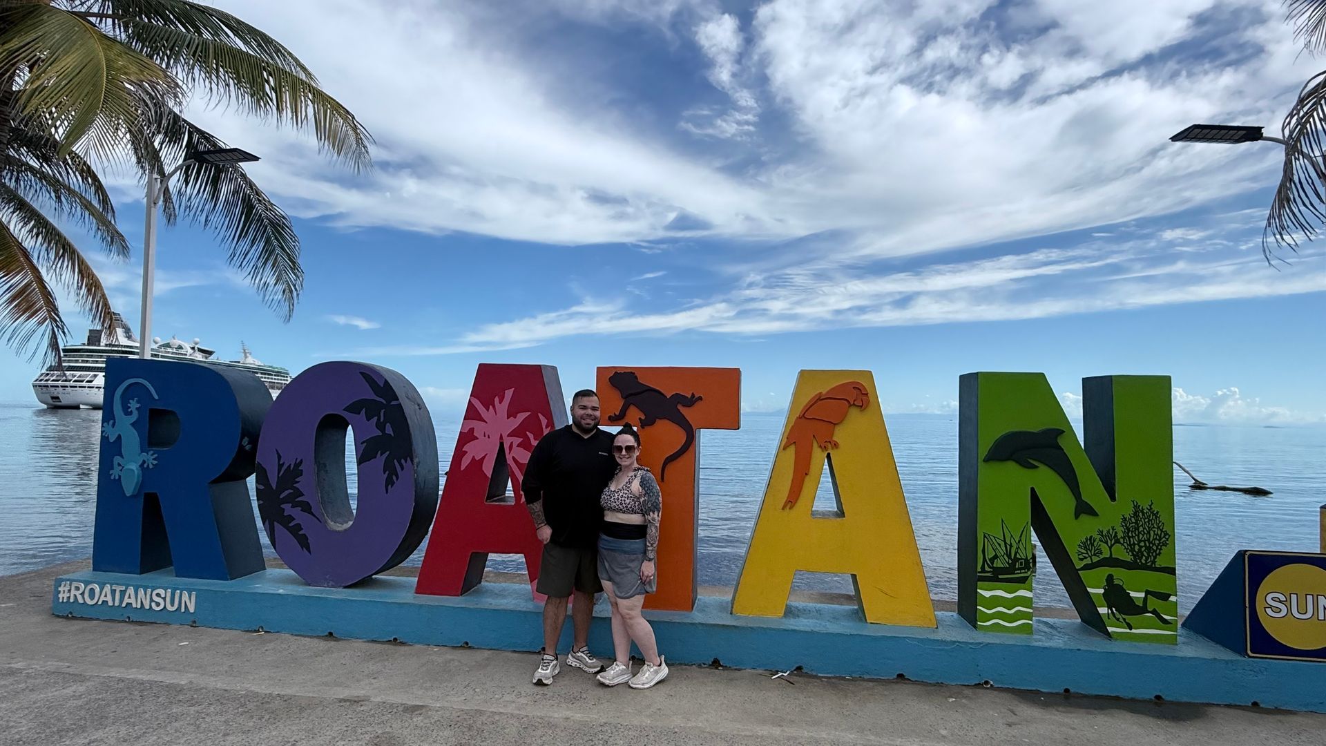 Couple posing in front of colorful
