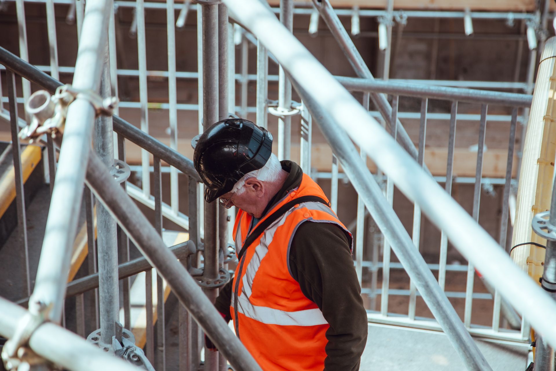 a construction worker wearing an orange vest and a hard hat