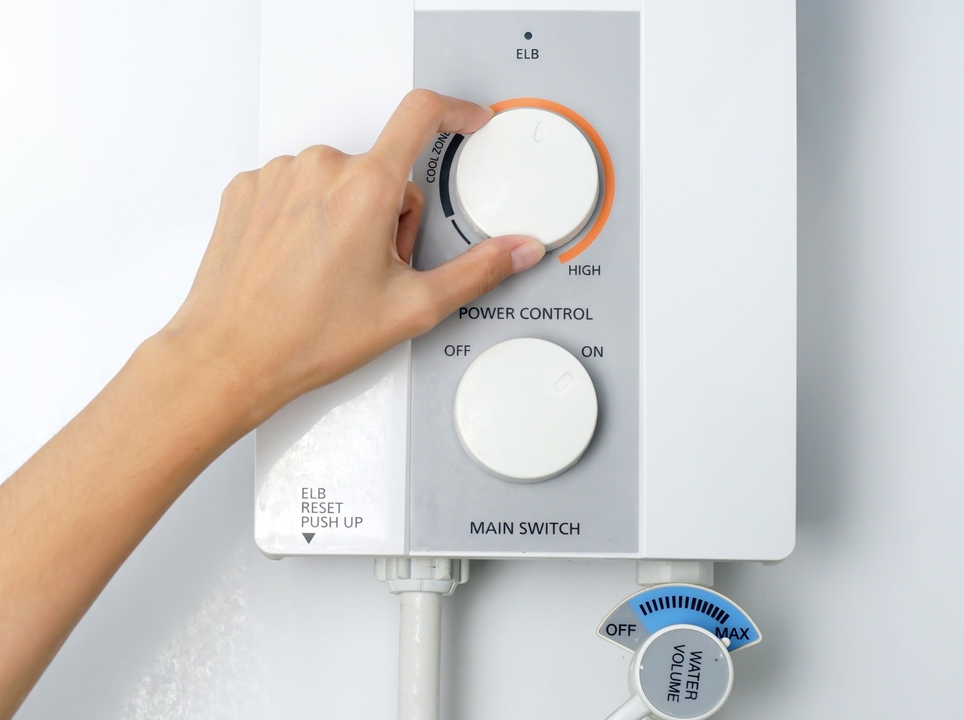 A person is adjusting the temperature of a water heater.