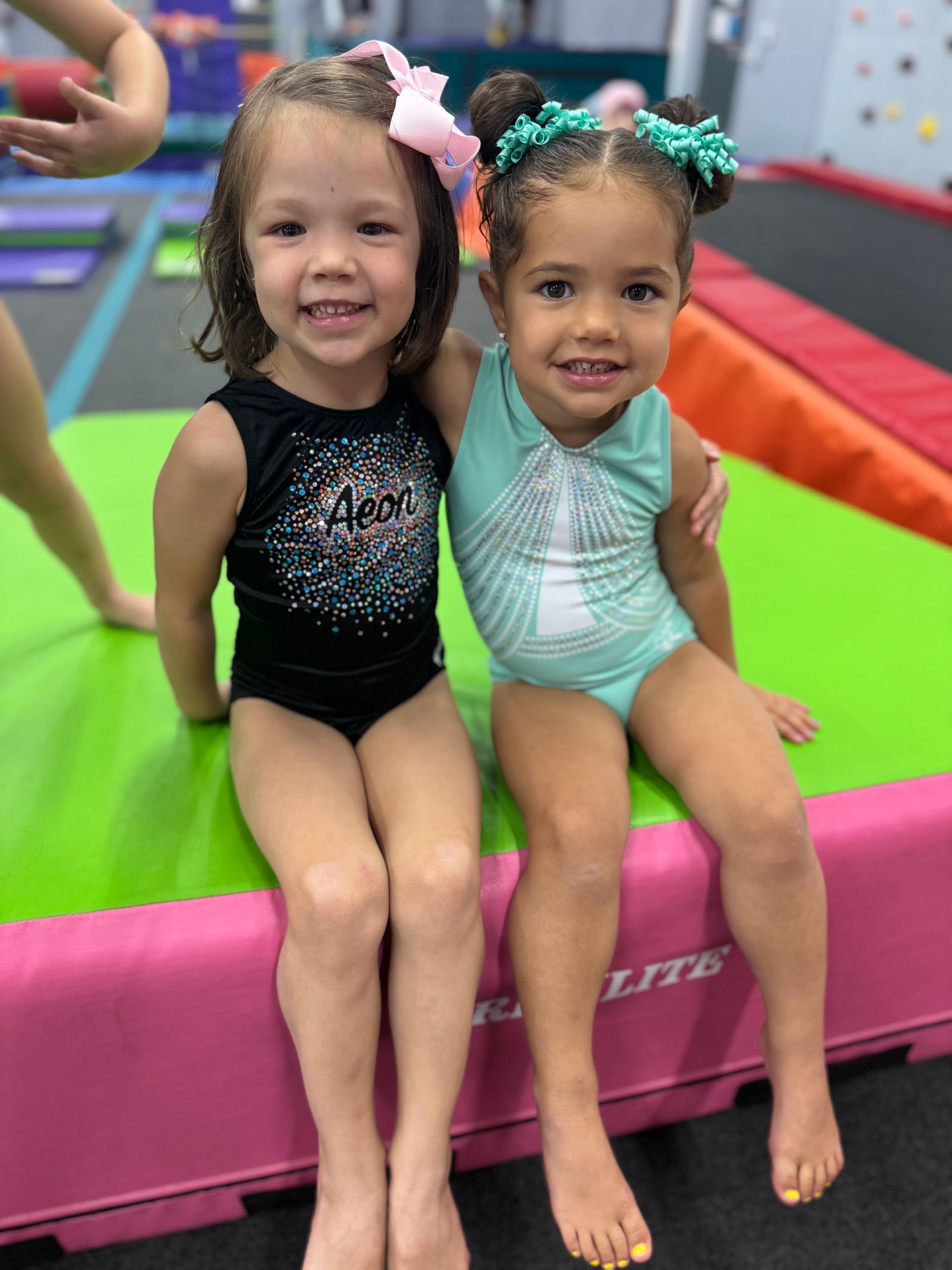 A little girl is playing with gymnastic rings in a gym