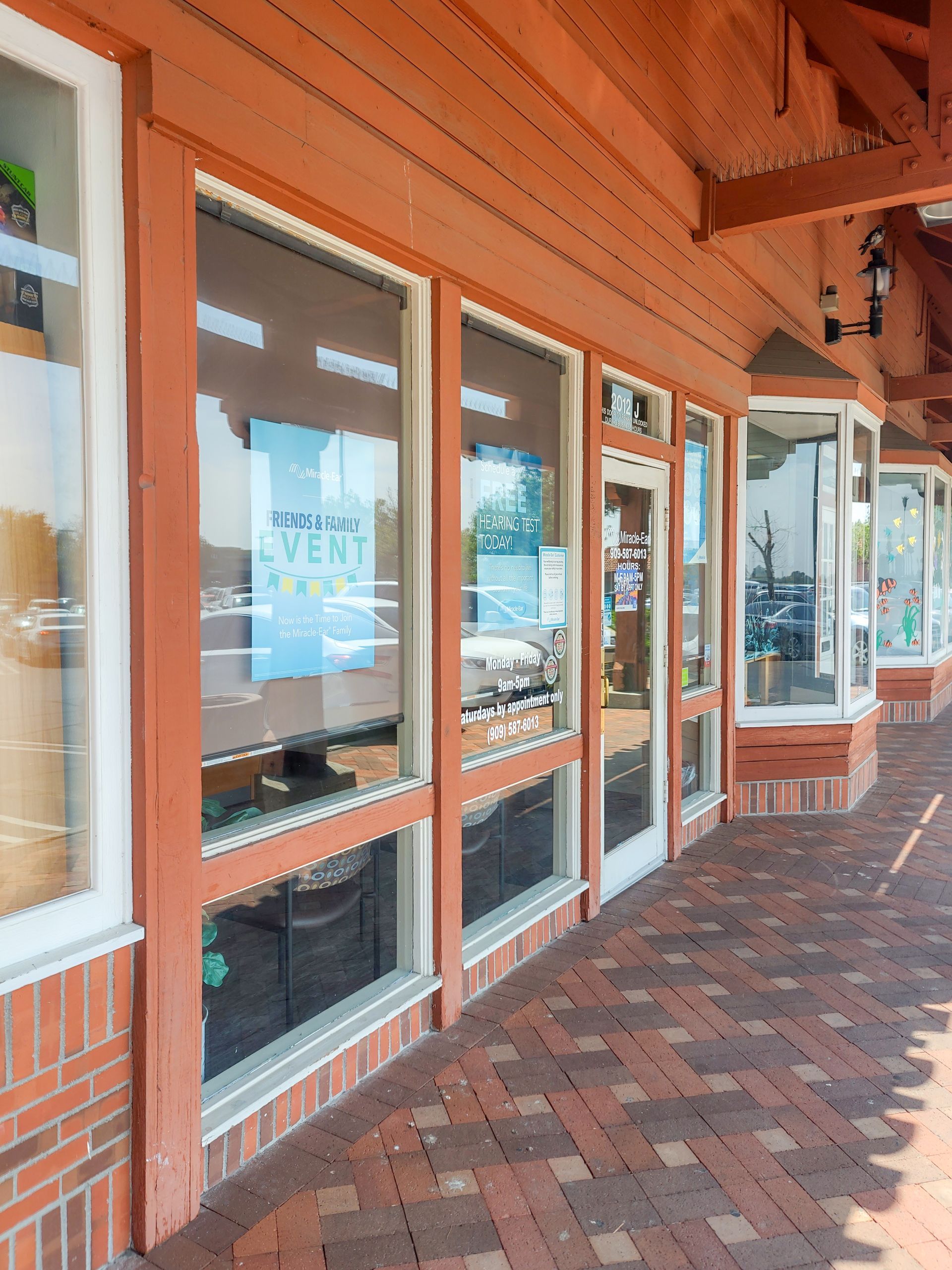 A brick building with a lot of tinted windows and doors