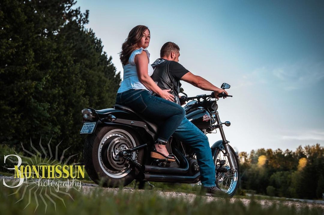 A man and a woman are riding a motorcycle.