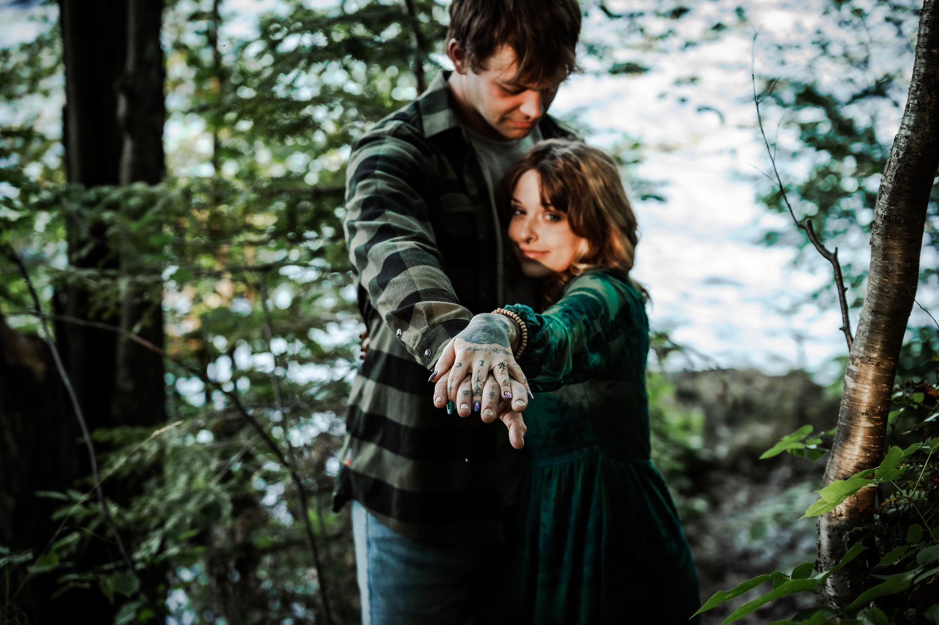 A bride and groom are kissing while sitting on a set of wooden stairs.