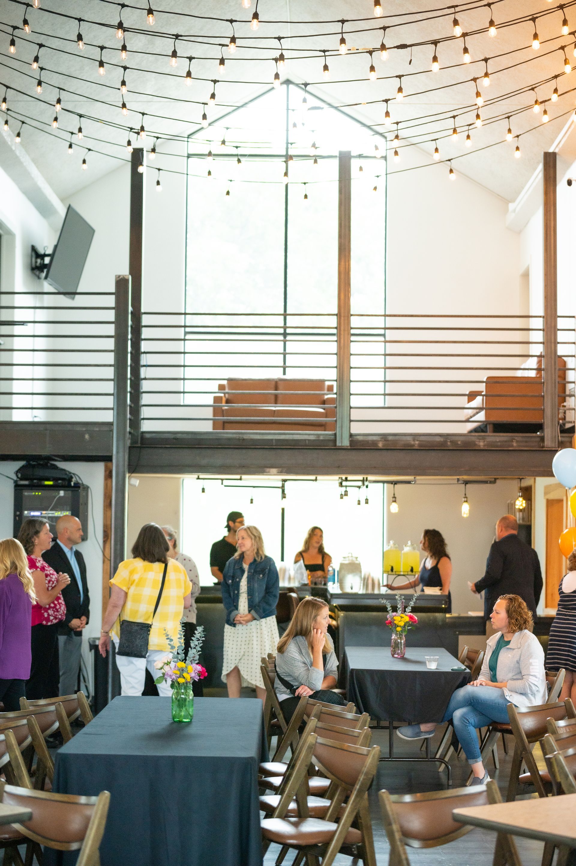 A photo booth is sitting in front of a blue couch.