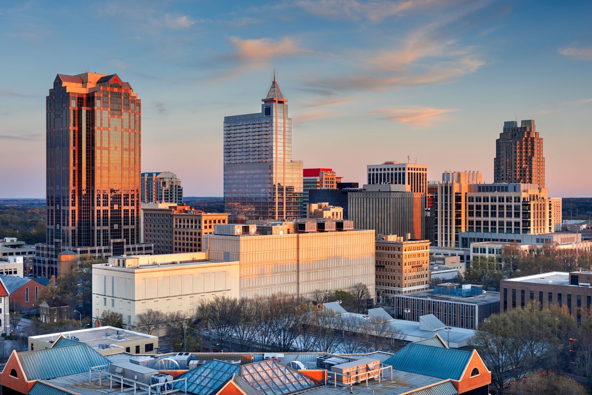 An aerial view of a city skyline at sunset.