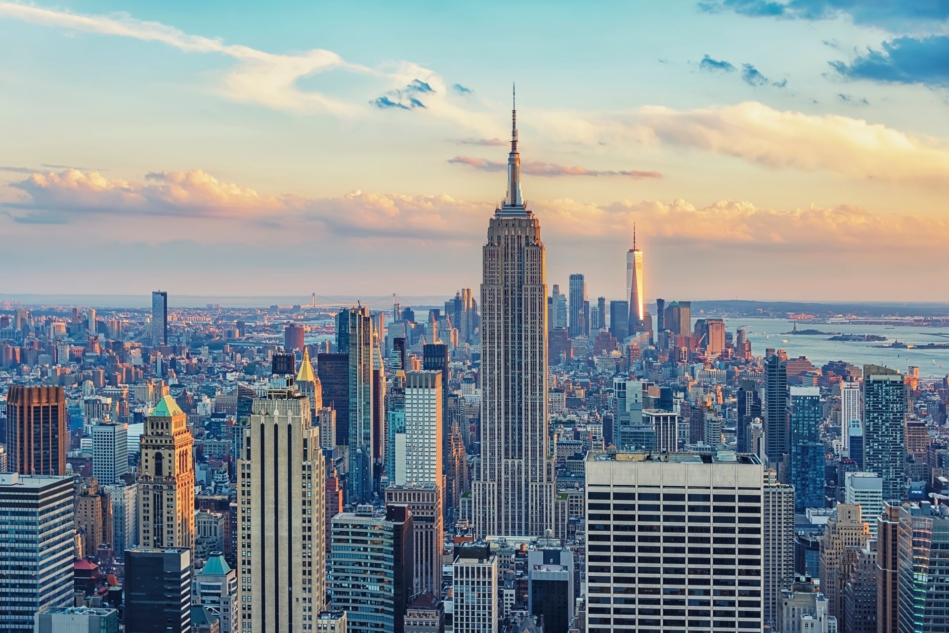 An aerial view of the skyline of new york city at sunset.