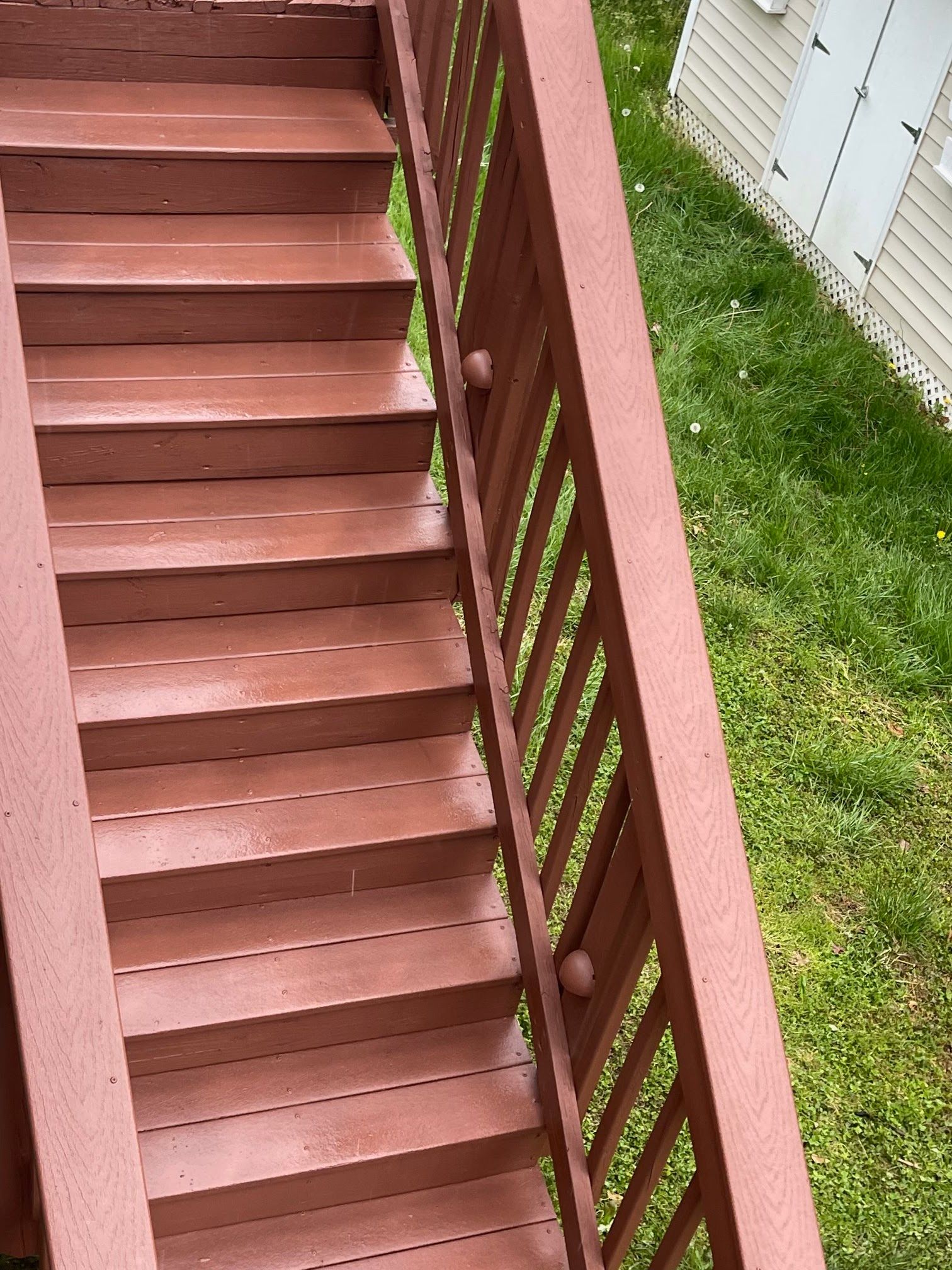 A set of wooden stairs leading up to a house.