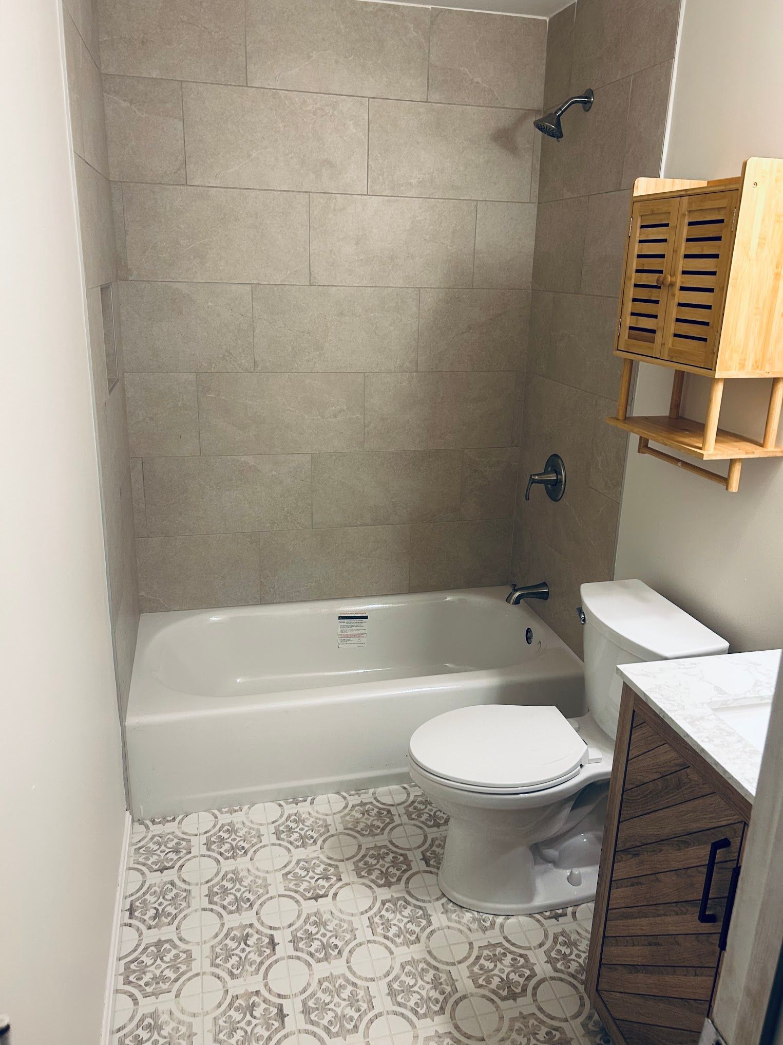 A bathroom with a tub , toilet , sink and shower.