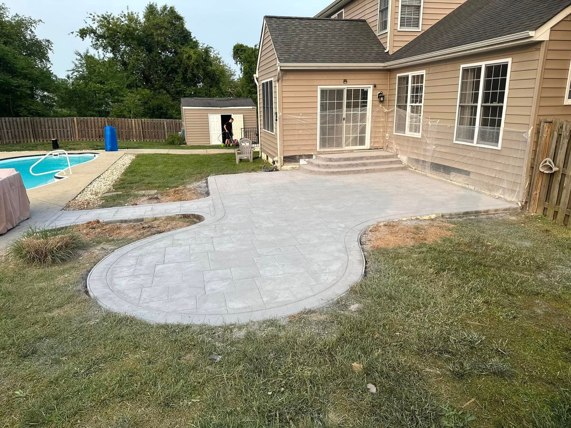 A house with a patio and a pool in the backyard.