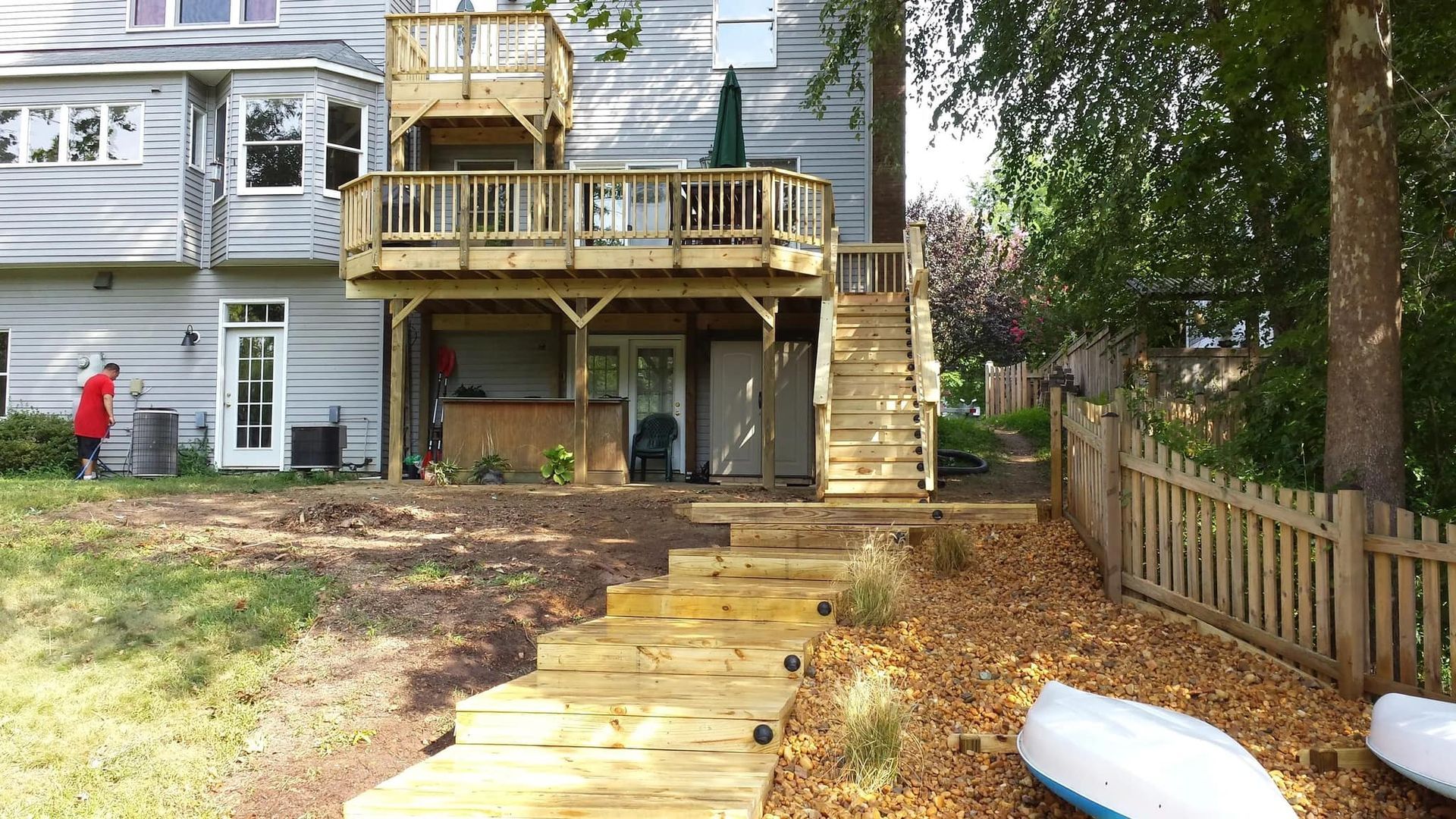 A house with a wooden deck and stairs leading to it